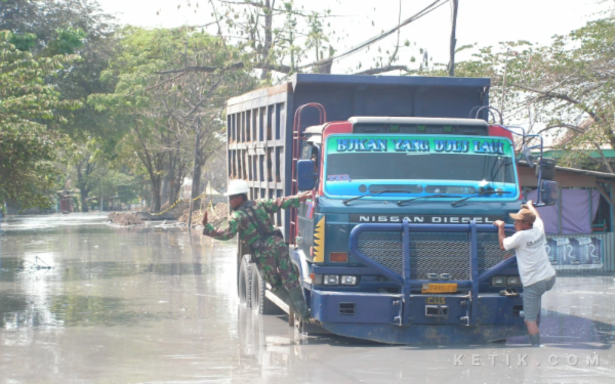 Foto Truk-truk dikerahkan untuk membantu evakuasi warga  Kelurahan Siring keluar dari kampung menuju rel kereta api di dekat Jalan Arteri Porong Lama. (Foto: Dokumen Fathur Roziq)