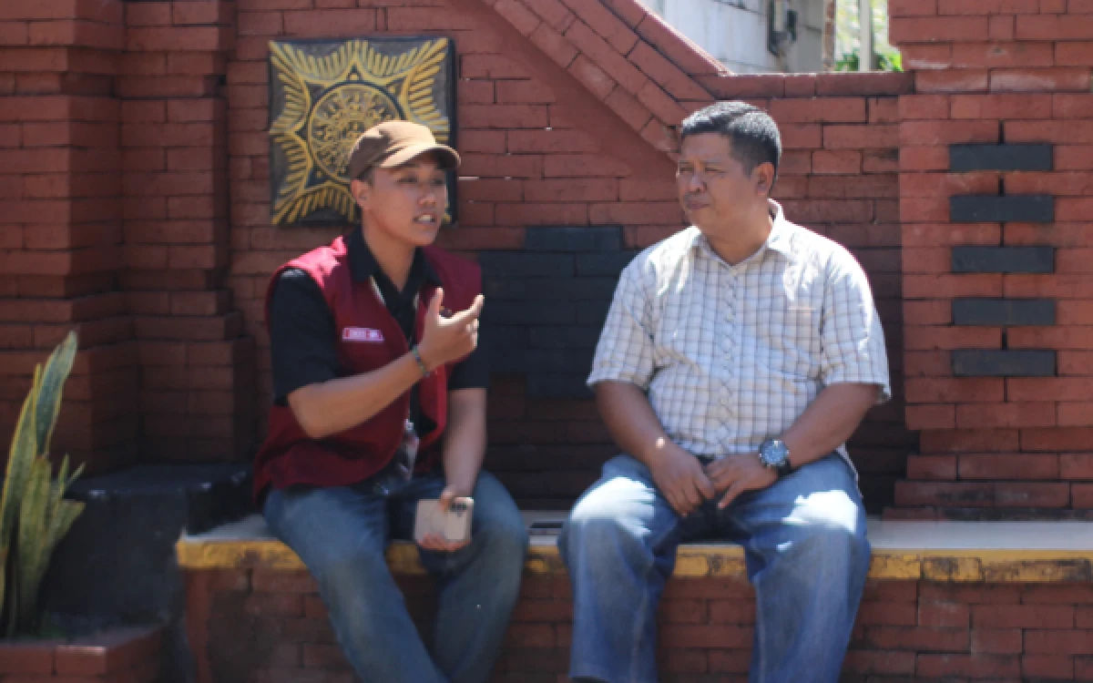 Foto Sosok Koko Qurrahman Prakoso selaku Ketua KKN 30 UINSA (kiri) bersama bapak Suyanto masyarakat setempat (kanan) saat melakukan wawancara usai mengikuti Sosialisasi dan simulasi lubang resapan biopori di salah satu halaman rumah warga pada Senin, 29 Juni 2026. (Foto: Ahmad Bintang Asyrof Sanny)
