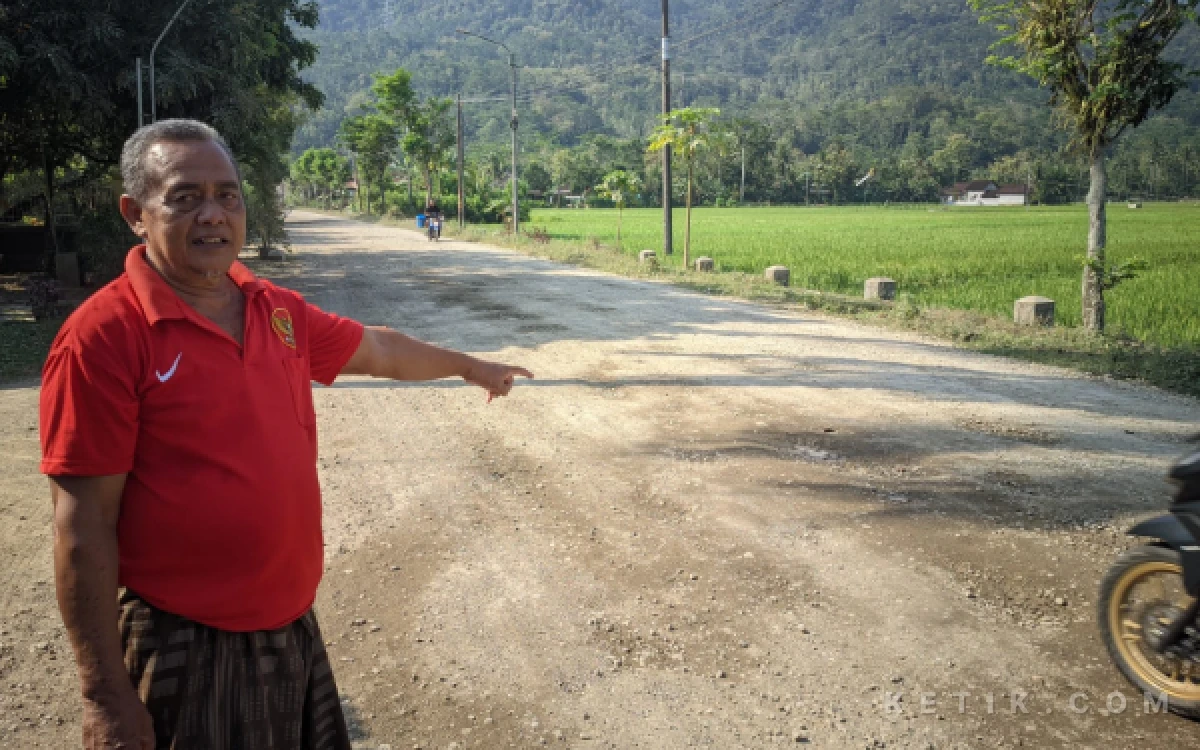 Foto Mulyono (68), warga Dusun Duduhan, Desa Mentoro, Kecamatan Pacitan, menunjukkan kondisi Jalan Prof. Dr. Moestopo yang rusak parah, Kamis (11/6/2026). Jalan yang telah rusak selama bertahun-tahun itu menjadi sumber debu yang mengganggu kesehatan dan aktivitas warga, serta disebut telah menyebabkan sejumlah kecelakaan lalu lintas di kawasan tersebut.