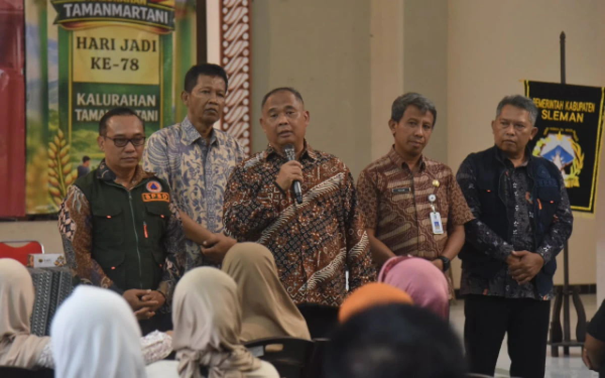 Foto Bupati Sleman, Harda Kiswaya, didampingi Kalak BPBD Sleman, Bambang Kuntoro (kiri) dan Lurah Tamanmartani Gandang Hardjanata (belakang), berdialog dengan warga penerima bantuan di Tamanmartani. Kehadiran para pejabat ini menunjukkan komitmen pemerintah daerah dalam merespons cepat kebutuhan warga pascabencana. (Foto: Pemkab Sleman for Ketik.com)